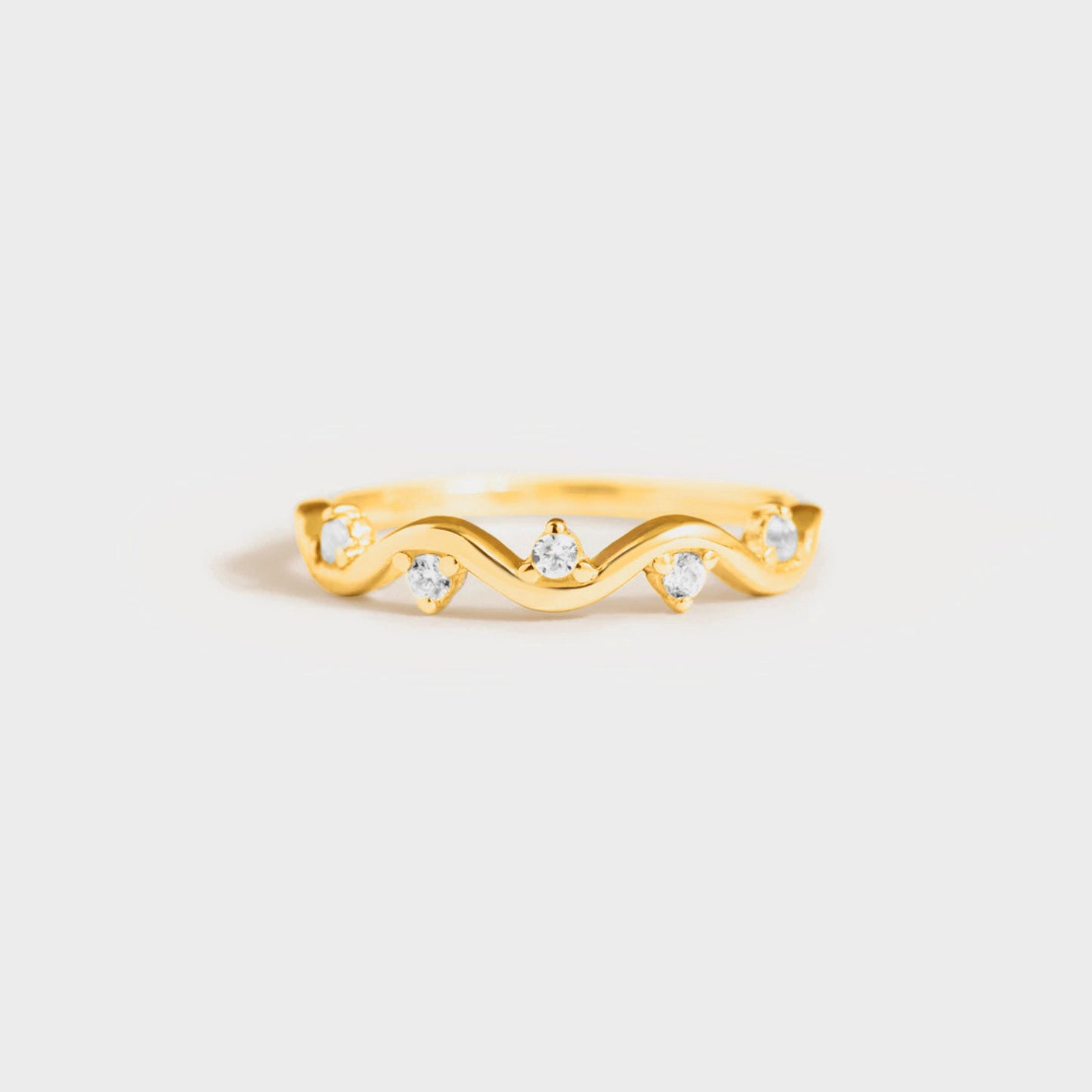 A gold-plated sterling silver ring with inlaid zircon stones set in a classic six-prong setting.