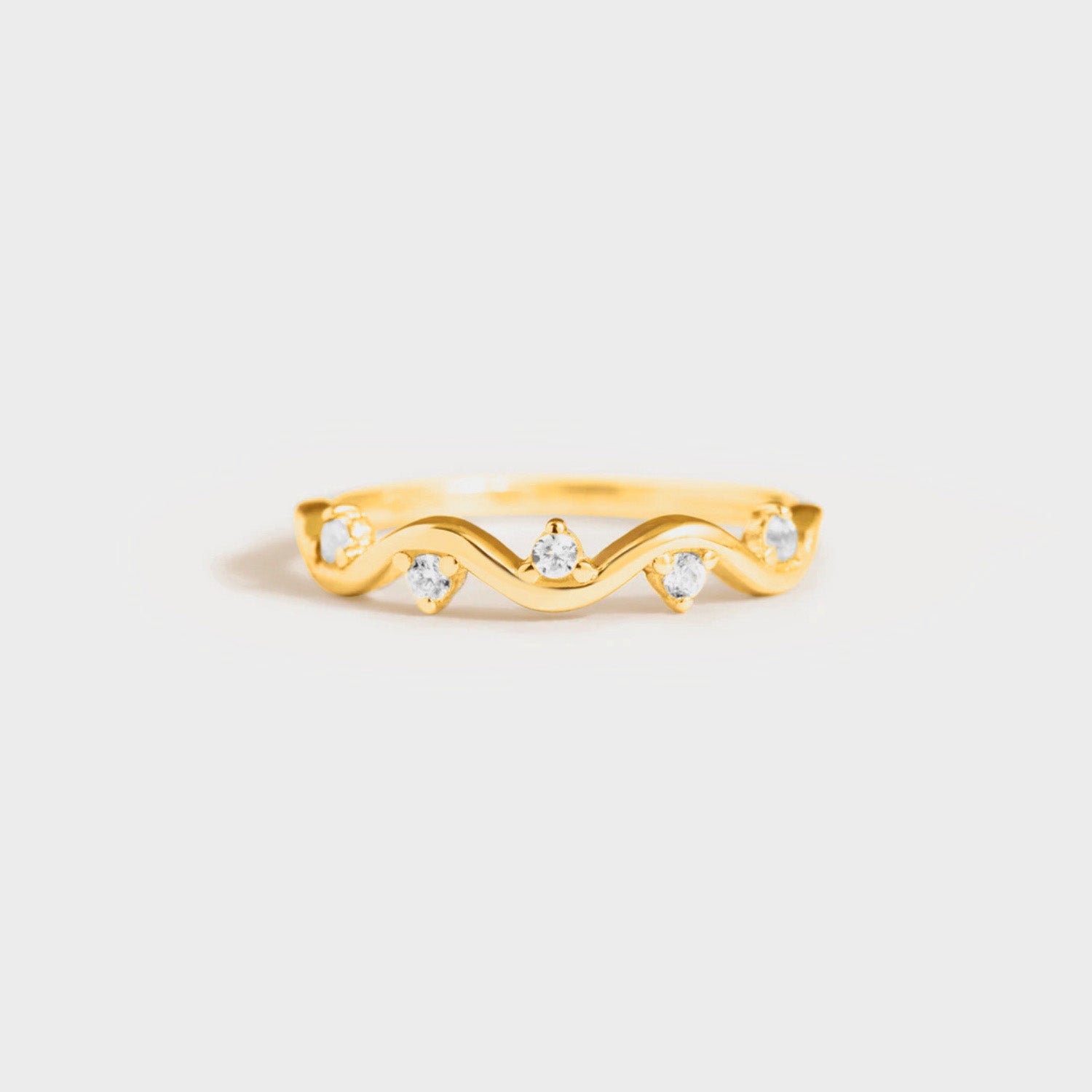 A gold-plated sterling silver ring with inlaid zircon stones set in a classic six-prong setting.