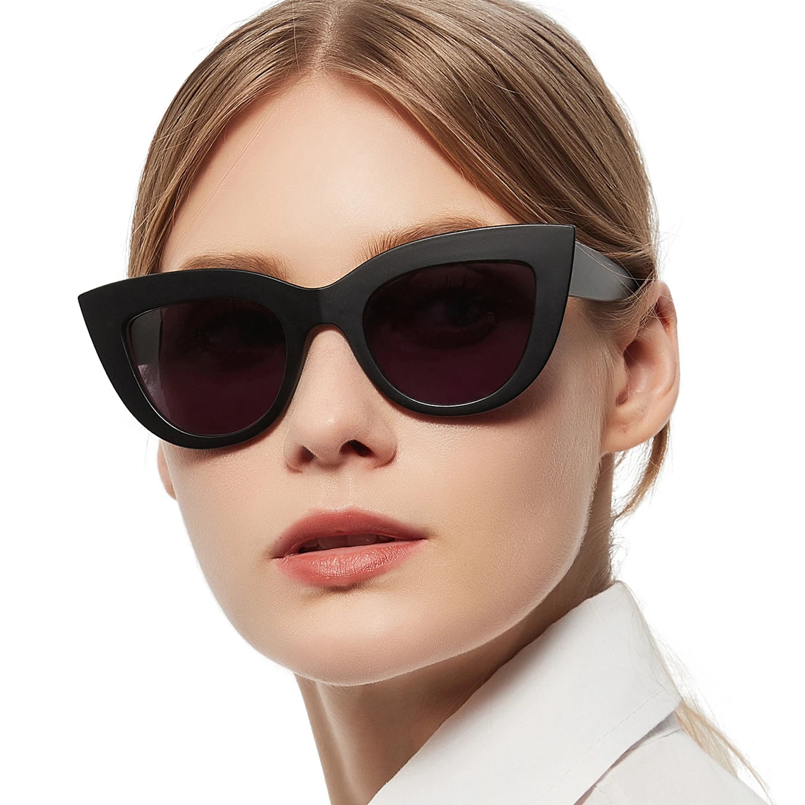 Close-up of a person wearing black cat-eye sunglasses with a white background