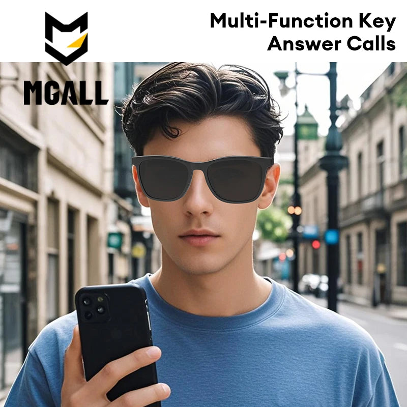 Man wearing sunglasses and holding a phone on a city street with MGALL branding.