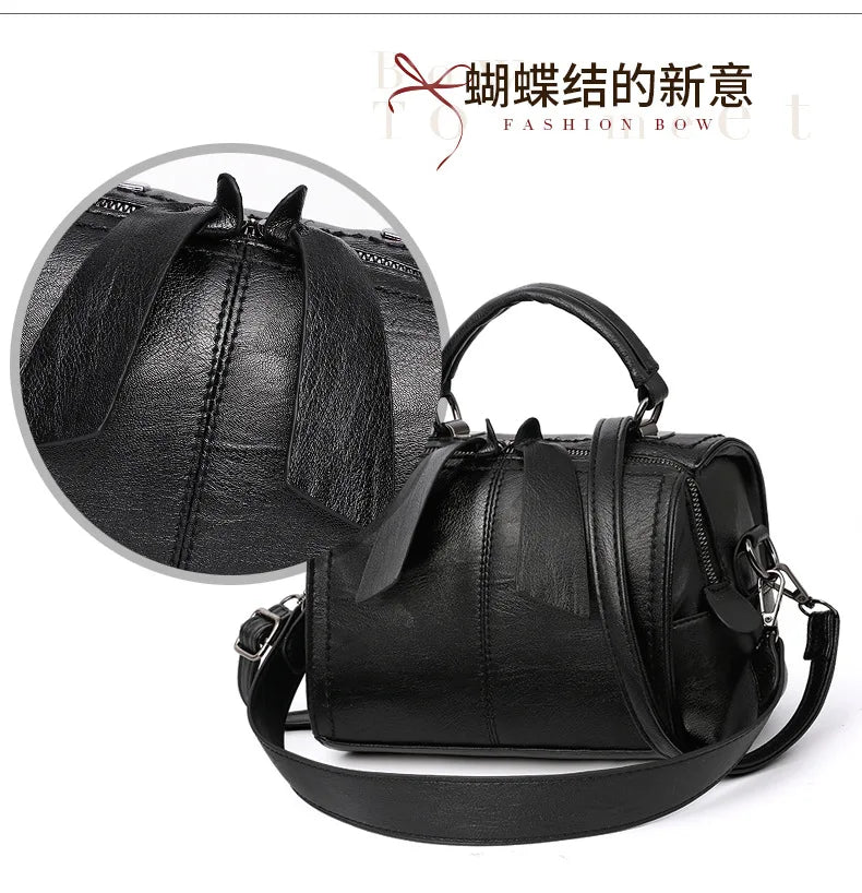 Black handbag with a close-up of the handle on a white background, featuring the brand 'Fashion Bow'.