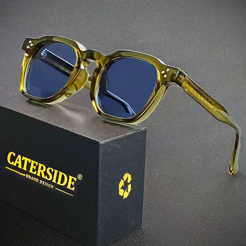 Sunglasses with yellow frames and blue lenses on a gray background, featuring the Caterside brand.