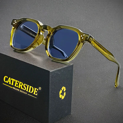 Sunglasses with yellow frames and blue lenses on a gray background, featuring the Caterside brand.