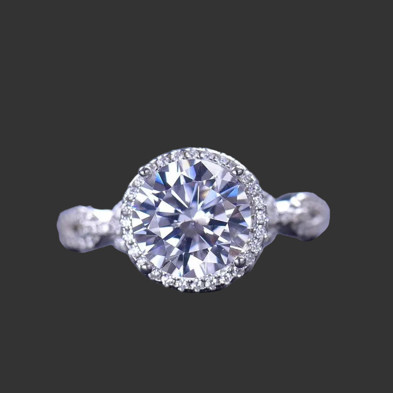 A 925 sterling silver ring with a central moissanite stone surrounded by smaller accent stones, 